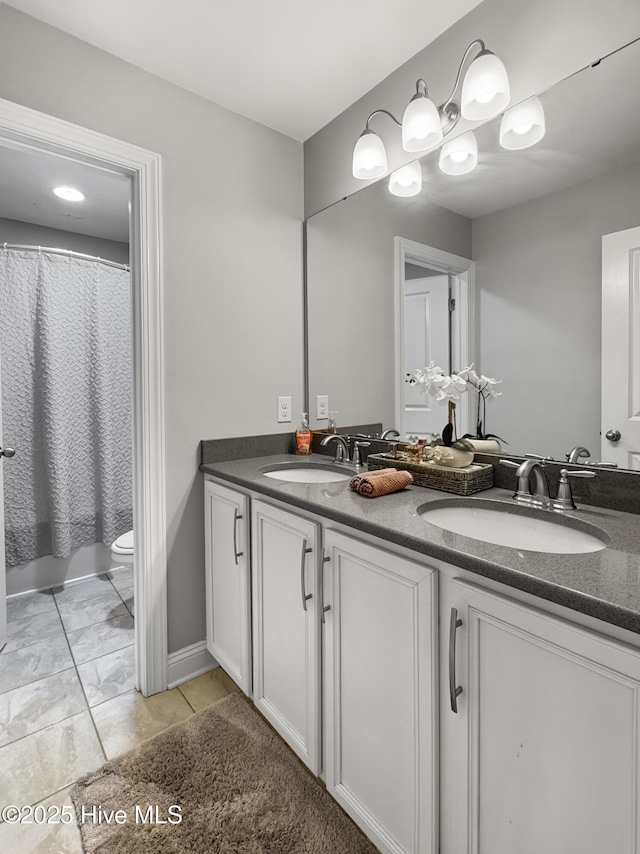 7845 Champlain Dr, Wilmington, NC 28412 - full bath with double vanity, a sink, marble finish floor, and toilet