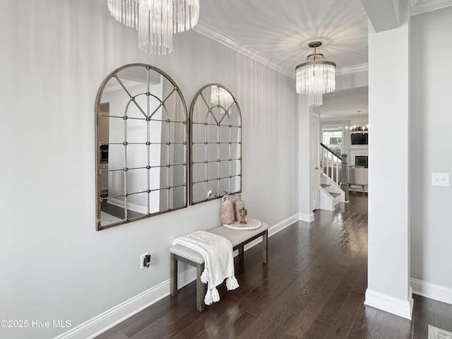7845 Champlain Dr, Wilmington, NC 28412 - hall featuring baseboards, ornamental molding, wood finished floors, and a chandelier