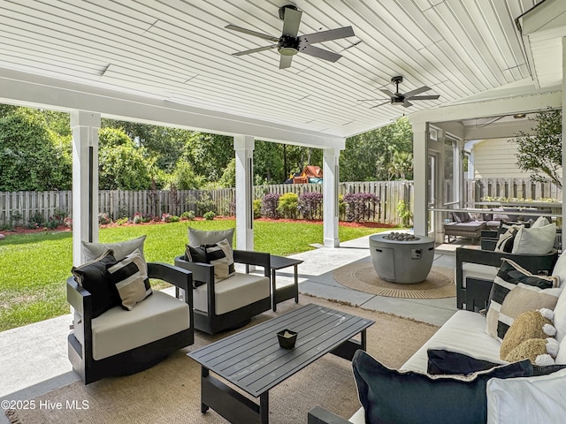7845 Champlain Dr, Wilmington, NC 28412 - view of patio featuring ceiling fan, a fenced backyard, and an outdoor living space with a fire pit