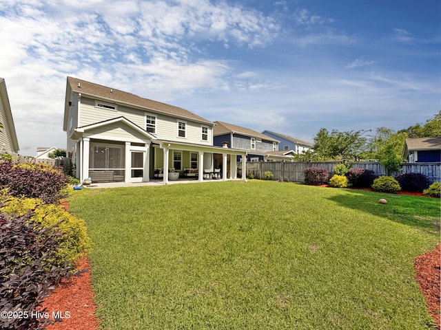 7845 Champlain Dr, Wilmington, NC 28412 - back of house featuring a lawn, a patio, fence, and a sunroom