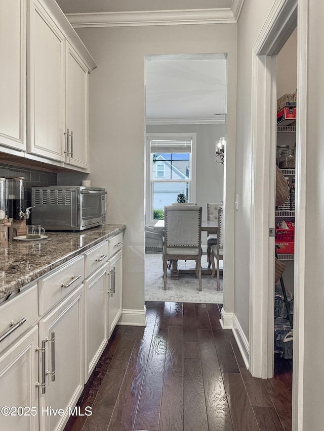 7845 Champlain Dr, Wilmington, NC 28412 - bar featuring crown molding, baseboards, a toaster, and dark wood-type flooring