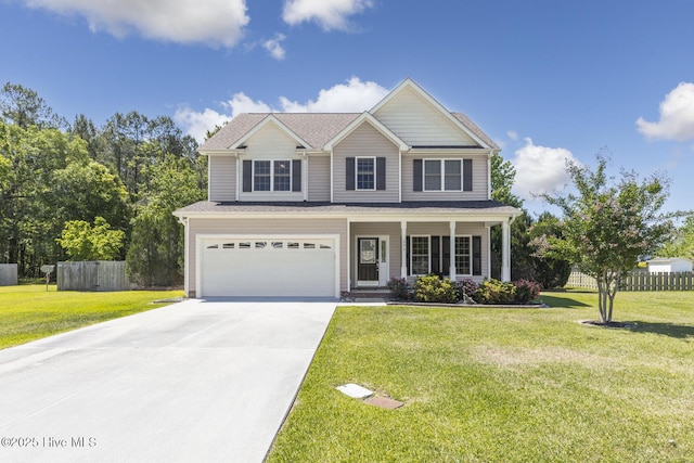 traditional home with fence, an attached garage, concrete driveway, and a front yard