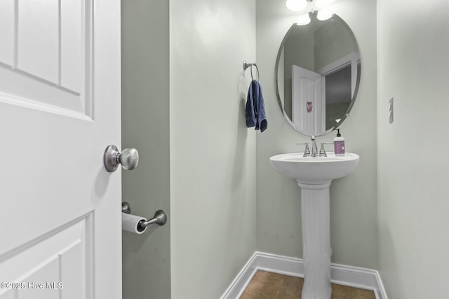 bathroom with baseboards and tile patterned floors