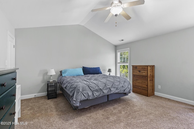 carpeted bedroom with visible vents, a ceiling fan, baseboards, and vaulted ceiling