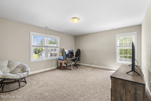 carpeted office space with baseboards and visible vents