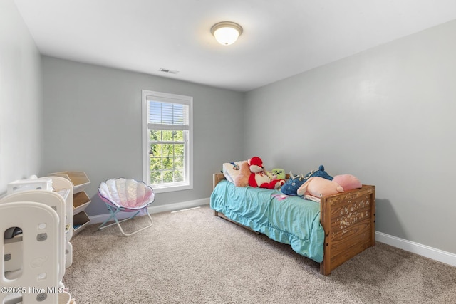 carpeted bedroom featuring baseboards and visible vents