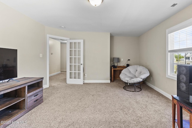 sitting room featuring french doors, baseboards, carpet floors, and visible vents
