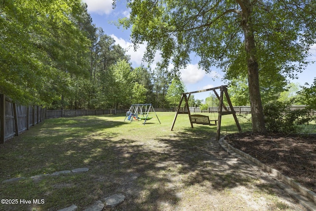 view of yard featuring a fenced backyard and a playground