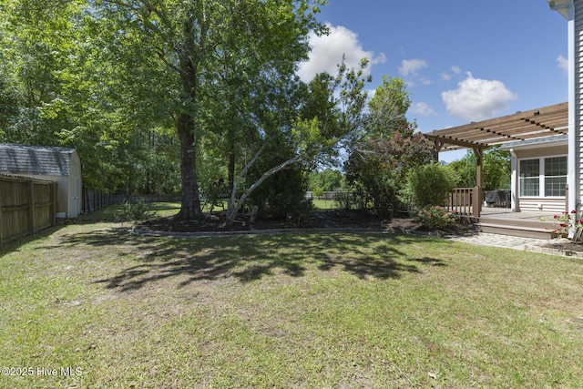 view of yard featuring a pergola, a wooden deck, and a fenced backyard