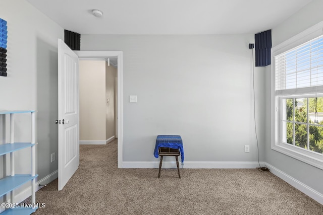 unfurnished bedroom featuring baseboards and carpet