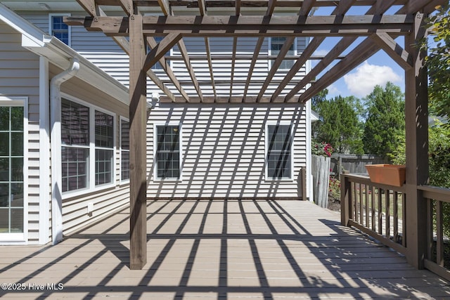 view of patio featuring fence, a pergola, and a deck