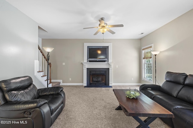 living room featuring baseboards, ceiling fan, carpet flooring, and stairs