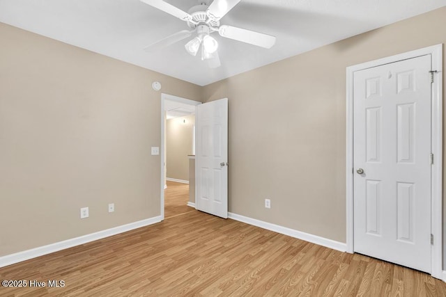 unfurnished bedroom featuring baseboards, ceiling fan, and light wood-type flooring