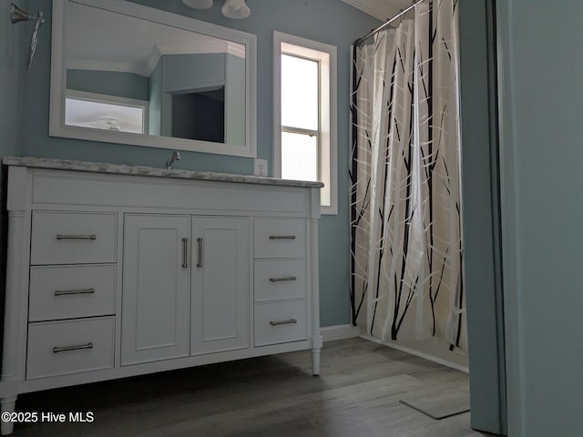 full bath with crown molding, wood finished floors, vanity, baseboards, and a shower with shower curtain