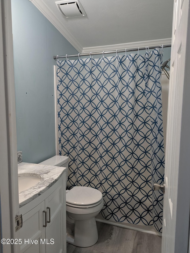 bathroom with visible vents, wood finished floors, toilet, ornamental molding, and a shower with shower curtain
