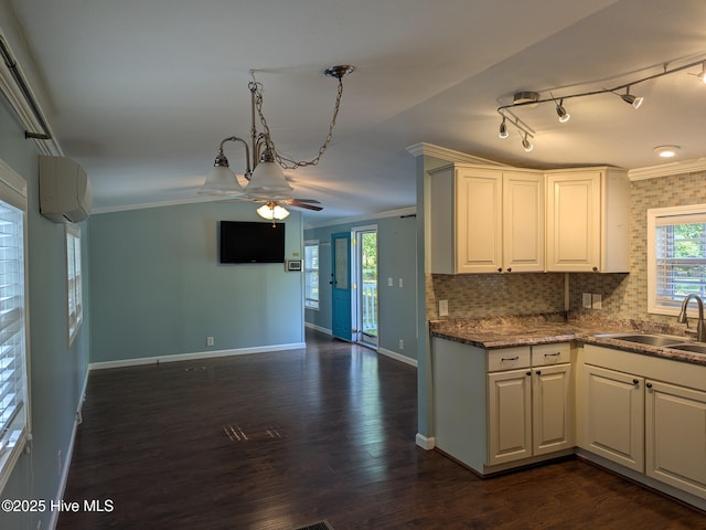 kitchen featuring a sink, ornamental molding, a ceiling fan, and a wall mounted air conditioner