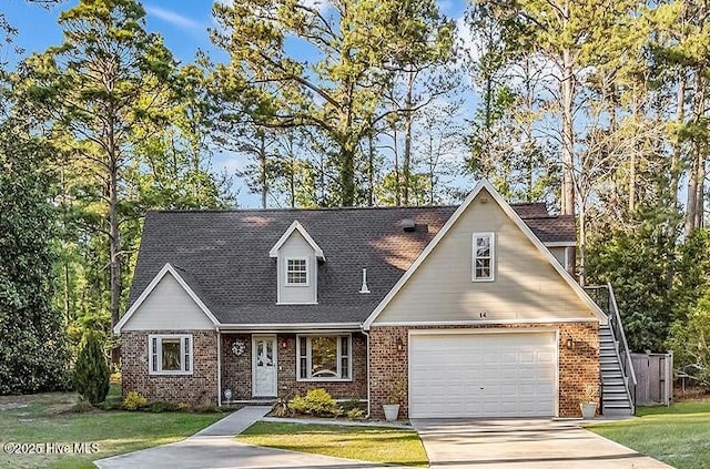 14 Palmer Dr, Shallotte, NC 28470 - view of front of property featuring concrete driveway, a garage, a front lawn, and brick siding