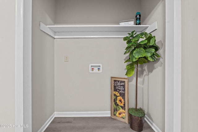 washroom featuring washer hookup, baseboards, laundry area, and wood finished floors