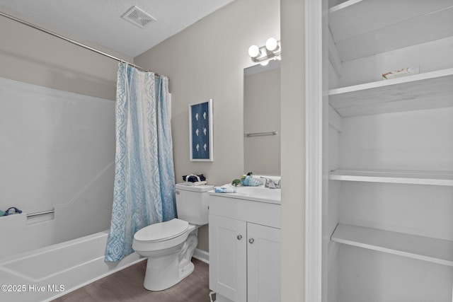 full bathroom with visible vents, shower / tub combo with curtain, vanity, wood finished floors, and toilet
