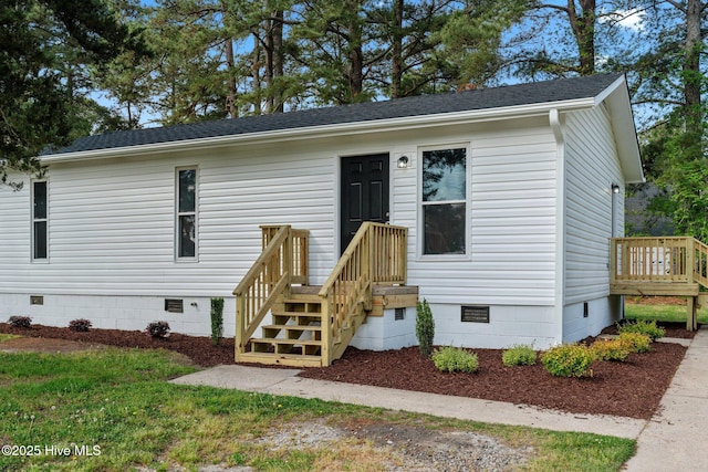 view of front of property featuring a shingled roof and crawl space