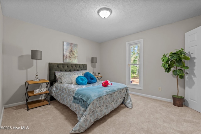 carpeted bedroom with a textured ceiling and baseboards
