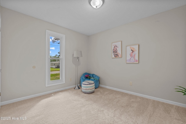 carpeted empty room with baseboards and visible vents