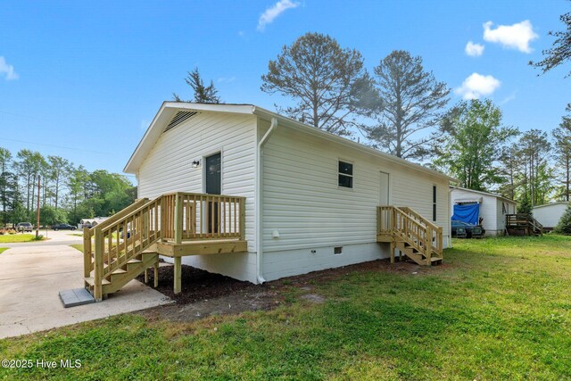 view of property exterior with a lawn and crawl space