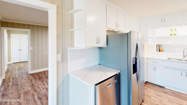kitchen with open shelves, stainless steel appliances, light wood-style flooring, white cabinets, and ornamental molding