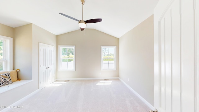 unfurnished bedroom with vaulted ceiling, baseboards, carpet floors, and a ceiling fan