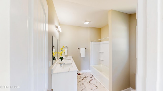 bathroom with marble finish floors, bathing tub / shower combination, double vanity, and baseboards