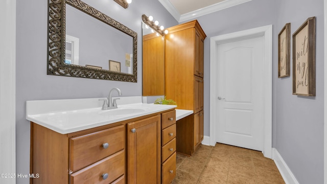bathroom with vanity, ornamental molding, baseboards, and tile patterned floors