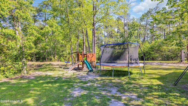 view of play area with a yard and a trampoline