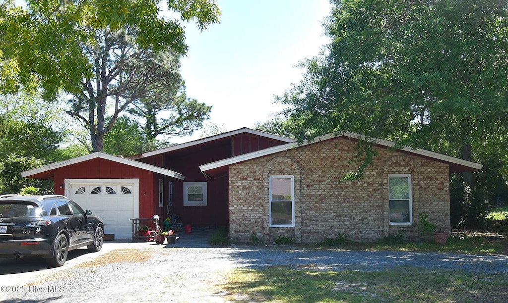 ranch-style home featuring brick siding and a garage