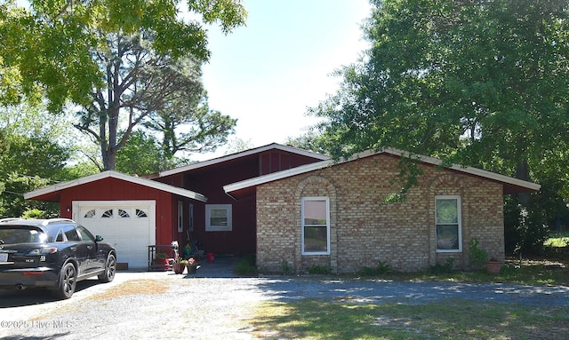 ranch-style home featuring brick siding and a garage