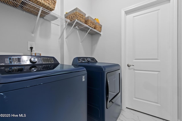 clothes washing area with laundry area, marble finish floor, and washing machine and dryer