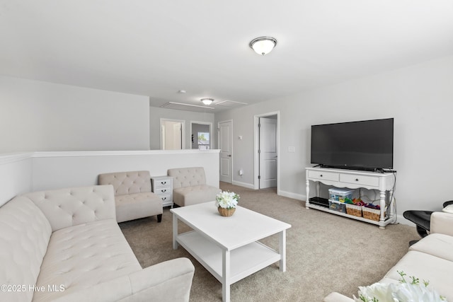 living room featuring baseboards, attic access, and carpet flooring