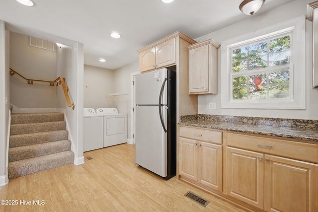 902 Hunnicutt Ave, Elizabeth City, NC 27909 - kitchen featuring freestanding refrigerator, visible vents, washer and dryer, light wood-style flooring, and light brown cabinets