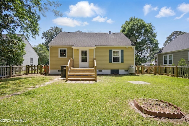 902 Hunnicutt Ave, Elizabeth City, NC 27909 - back of property with a yard, a shingled roof, a fenced backyard, and crawl space