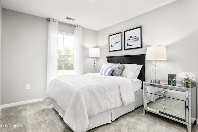 carpeted bedroom featuring baseboards and visible vents