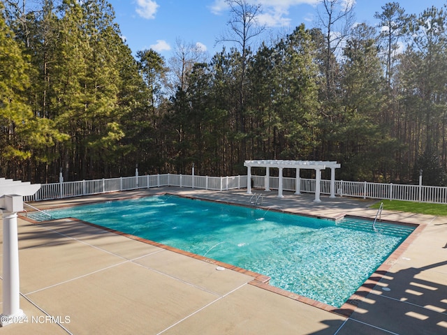 view of swimming pool with a fenced in pool, a patio area, fence, and a pergola