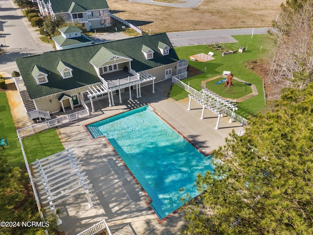 view of swimming pool featuring a fenced in pool, fence, a yard, and a patio