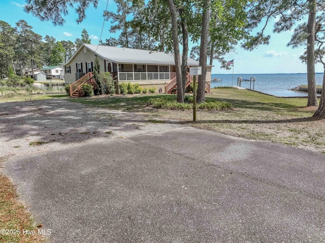 966 W Island View Rd, Bath, NC 27808 - ranch-style house featuring stairway, a water view, a sunroom, and a front lawn