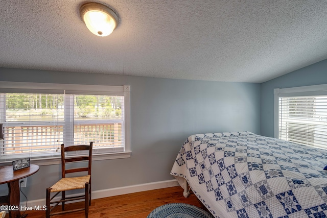 966 W Island View Rd, Bath, NC 27808 - bedroom featuring baseboards, a textured ceiling, wood finished floors, and multiple windows