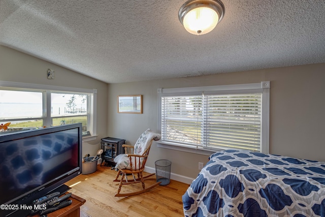 966 W Island View Rd, Bath, NC 27808 - bedroom featuring multiple windows, vaulted ceiling, light wood-type flooring, and a textured ceiling