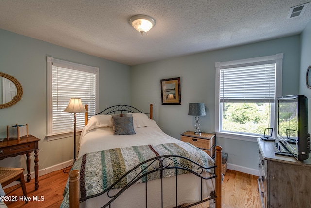 966 W Island View Rd, Bath, NC 27808 - bedroom with visible vents, a textured ceiling, light wood-style flooring, and baseboards