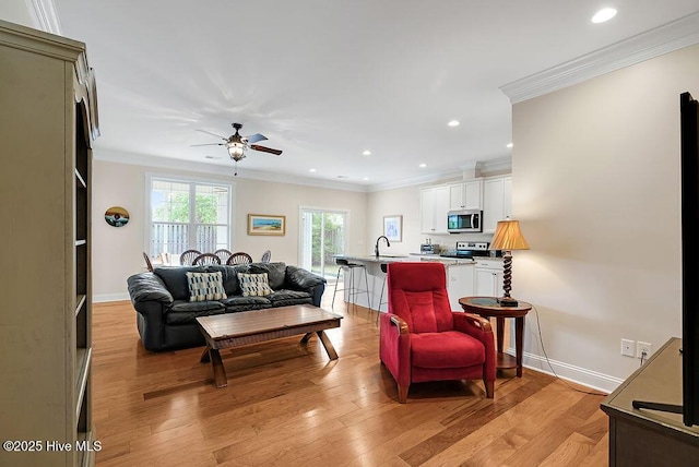 102 SW 8th St, Oak Island, NC 28465 - living area with crown molding, recessed lighting, ceiling fan, and light wood-style flooring