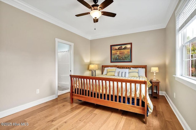 102 SW 8th St, Oak Island, NC 28465 - bedroom with ceiling fan, crown molding, wood finished floors, baseboards, and connected bathroom