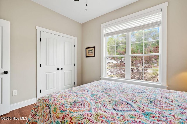 102 SW 8th St, Oak Island, NC 28465 - bedroom with dark wood-style flooring, baseboards, and a closet