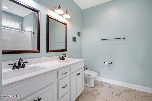 102 SW 8th St, Oak Island, NC 28465 - bathroom with double vanity, toilet, a sink, and marble finish floor