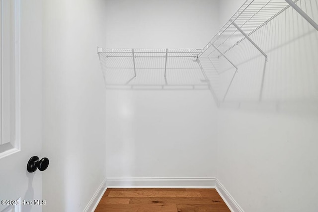 102 SW 8th St, Oak Island, NC 28465 - walk in closet featuring wood finished floors